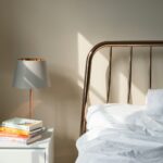 table lamp on white wooden nightstand beside bed